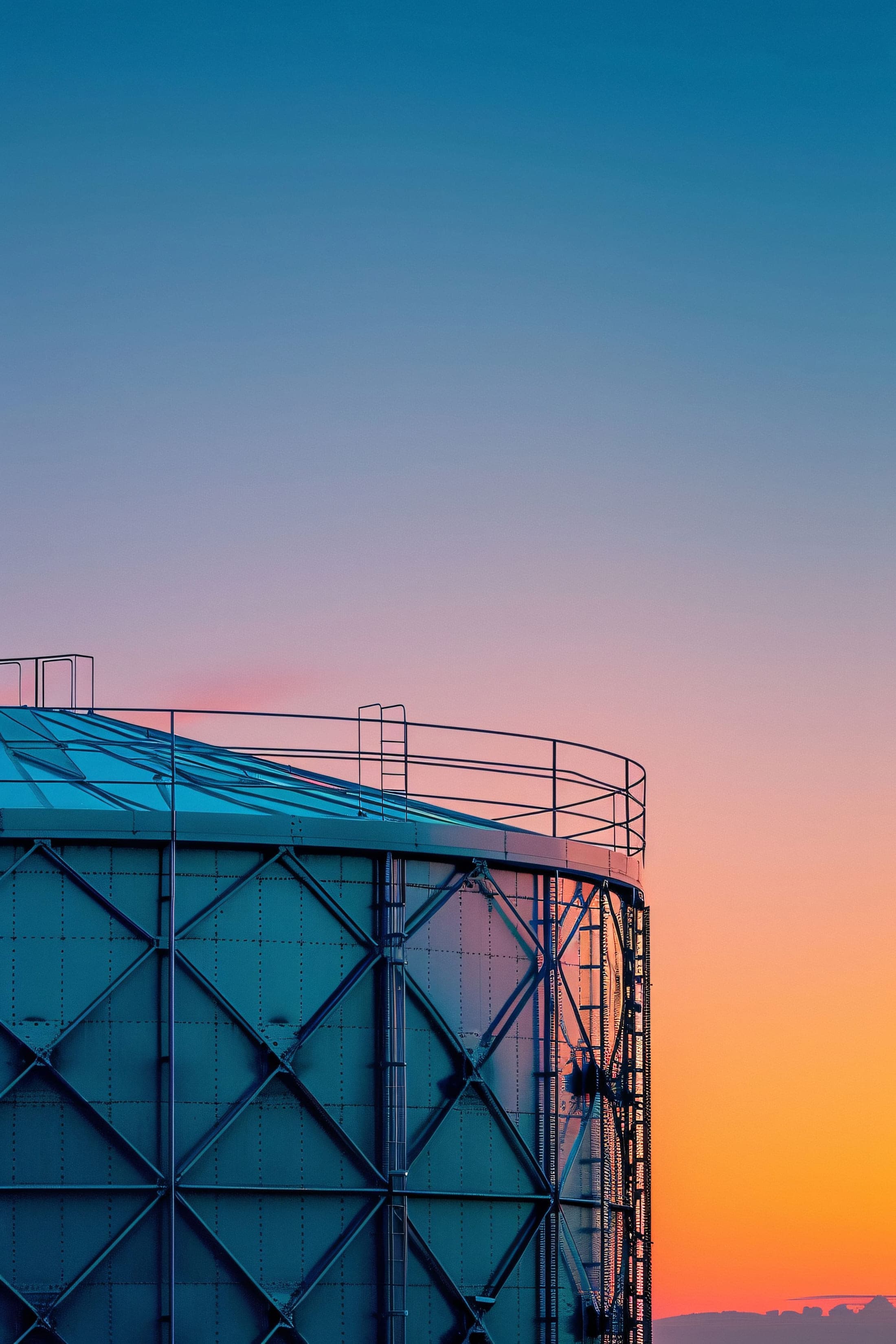 Industrial storage tank at sunset
